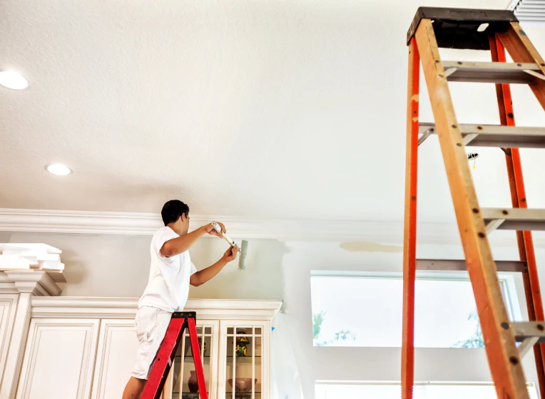 worker painting home interior
